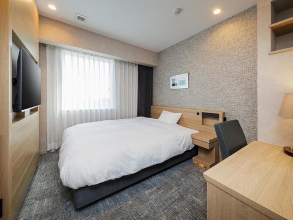 a hotel room with a bed and a desk and a computer at Soma Station Hotel - Vacation STAY 40258v in Soma