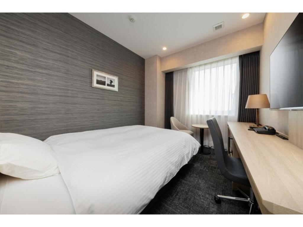 a hotel room with two beds and a desk at Soma Station Hotel - Vacation STAY 40250v in Soma