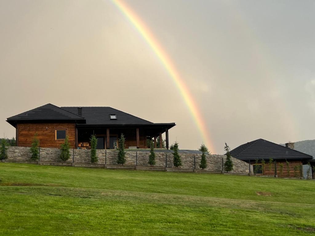 a rainbow in the sky over a house at Bielańska Ostoja in Uście Gorlickie