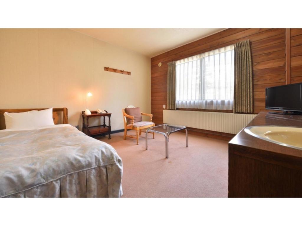 a hotel room with a bed and a sink at Hotel Takimoto - Vacation STAY 43492v in Yamanouchi