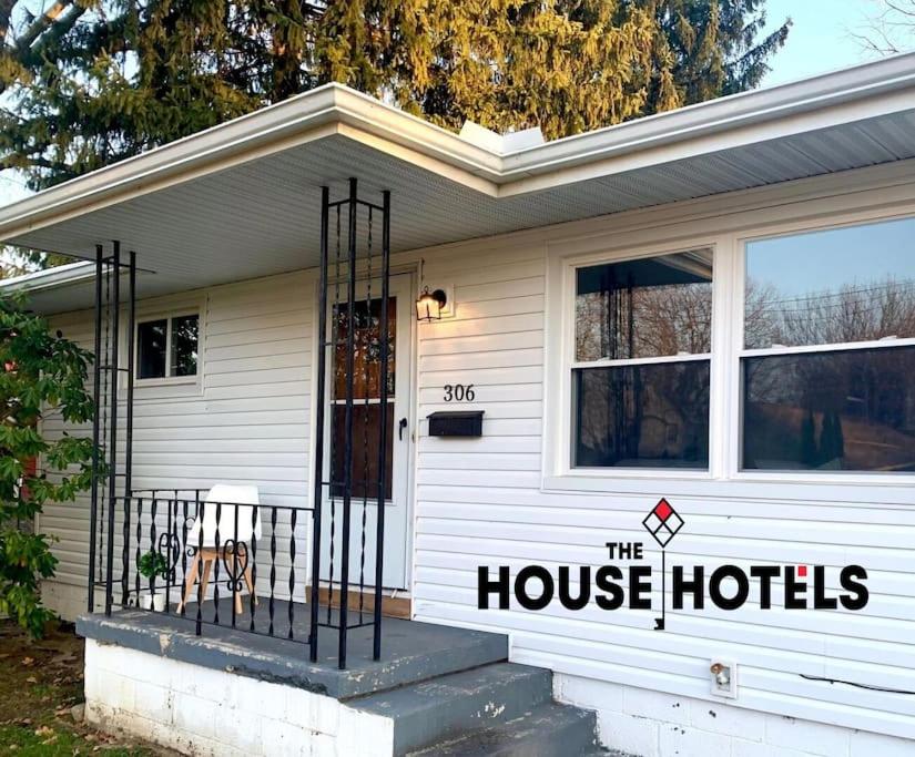 a house with a sign on the side of it at The House Hotels - Erie St. 2 in Cuyahoga Falls