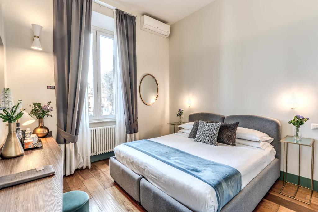 Postel nebo postele na pokoji v ubytování Tree Charme Trilussa