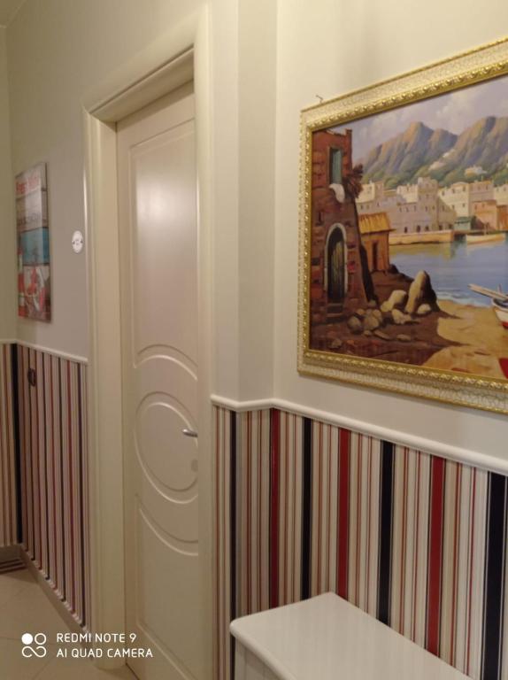 a door in a room with a painting on the wall at B&B Il Viaggiatore in Diamante