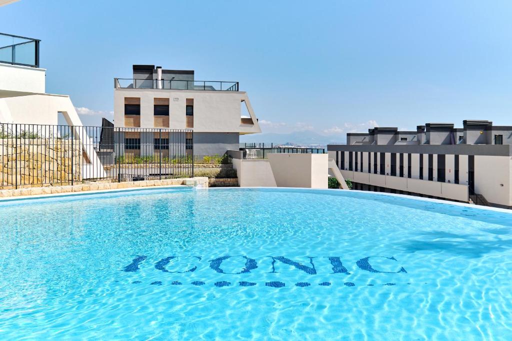 a swimming pool on the roof of a building at Playa Carabassi Sea View Apartment in Gran Alacant, Large Terrace in Gran Alacant