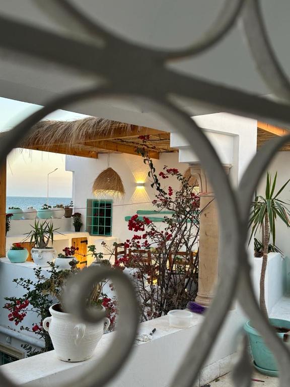 a view of a house with flowers and a balcony at Dar El Mahdia by Daldoul in Mahdia