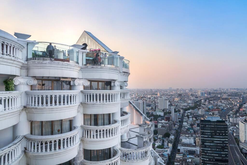 a tall white building with people on the balcony at Iconic skyline, Big apartment, Great location in Bangkok