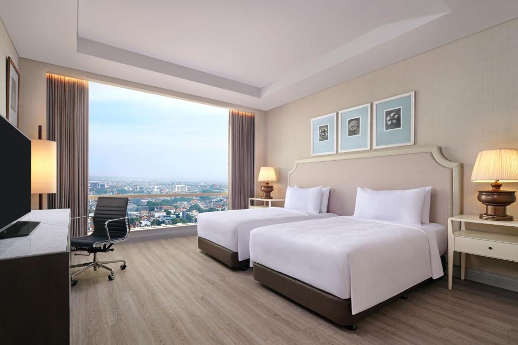 Postel nebo postele na pokoji v ubytování JW Marriott Hotel Surabaya