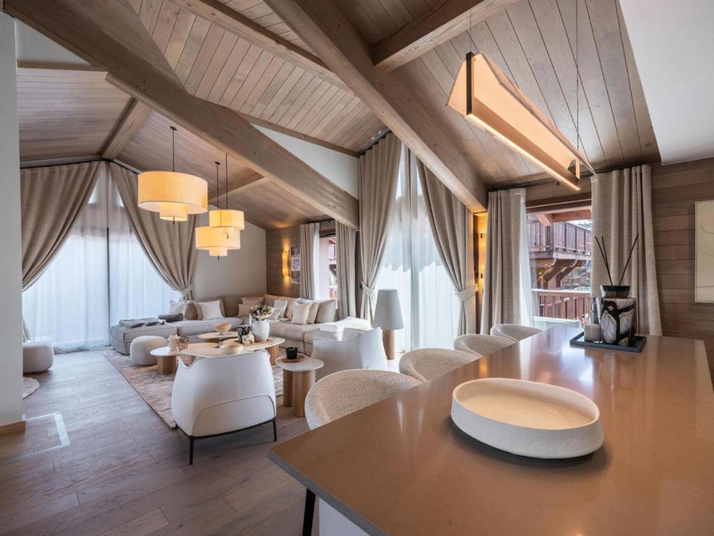 a large living room with white chairs and tables at Résidence Goyard - Chalets pour 12 Personnes 184 in Courchevel