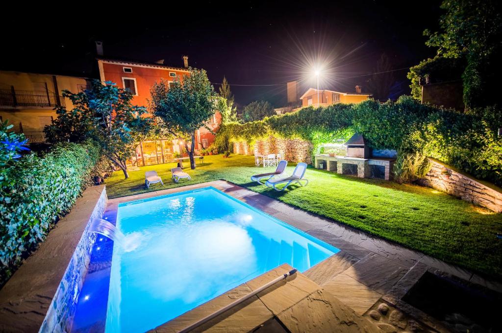 a swimming pool in a yard at night at B&B Il Soccorso in Mercatello sul Metauro