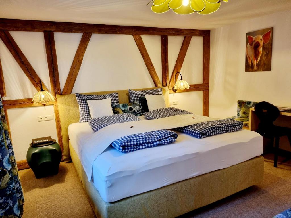 a bedroom with a large bed with blue pillows at Schittlerhof in Fischen