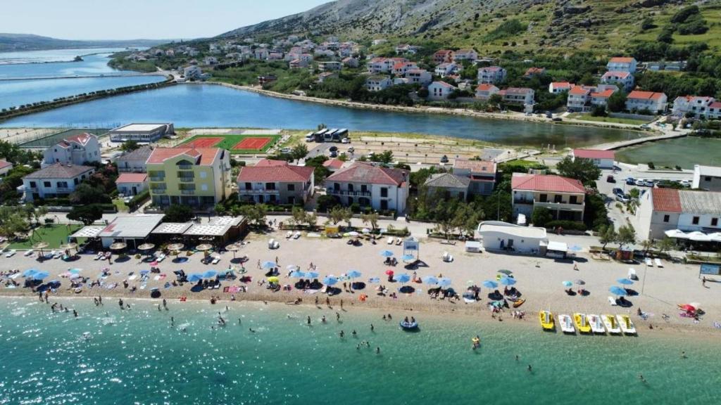 an aerial view of a beach with people and umbrellas at Villa Gabriel in Pag