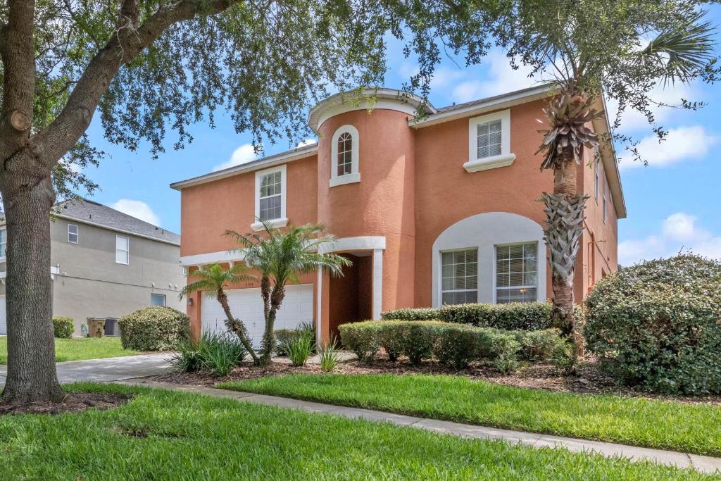 a brick house with trees in front of it at Be-Our-Guest Home! 15 mins to Disney! in Kissimmee