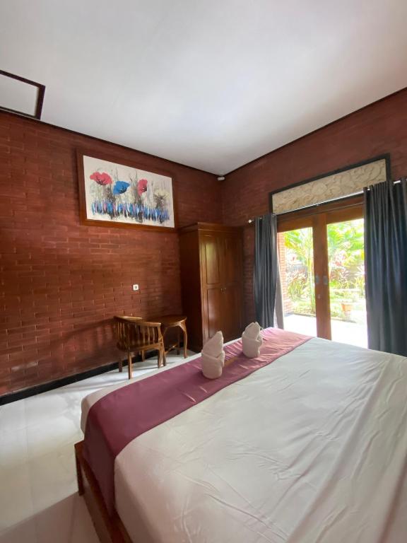 Postel nebo postele na pokoji v ubytování Tebu menjangan homestay
