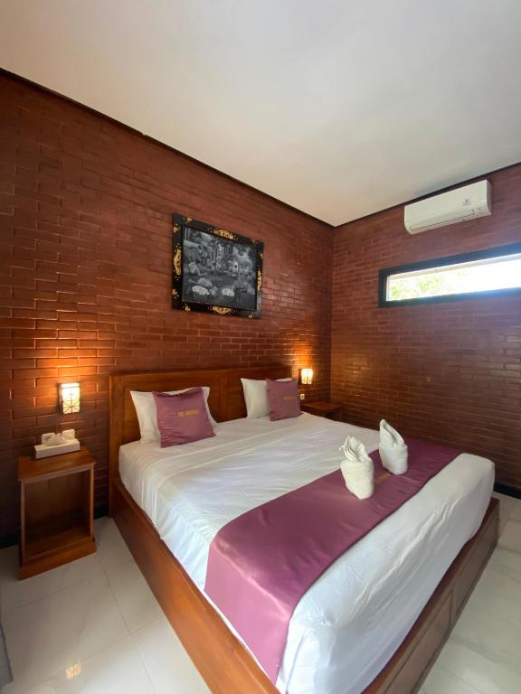 Postel nebo postele na pokoji v ubytování Tebu menjangan homestay