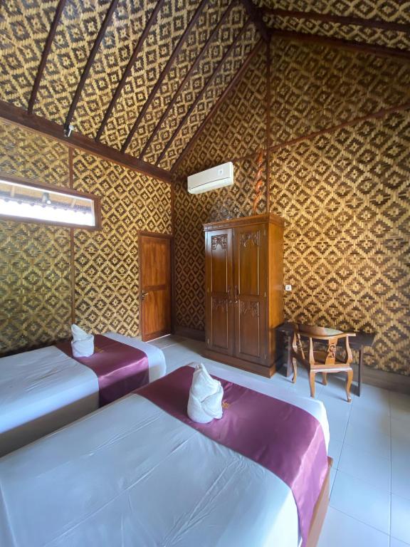 Postel nebo postele na pokoji v ubytování Tebu menjangan homestay