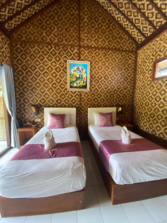 Postel nebo postele na pokoji v ubytování Tebu menjangan homestay