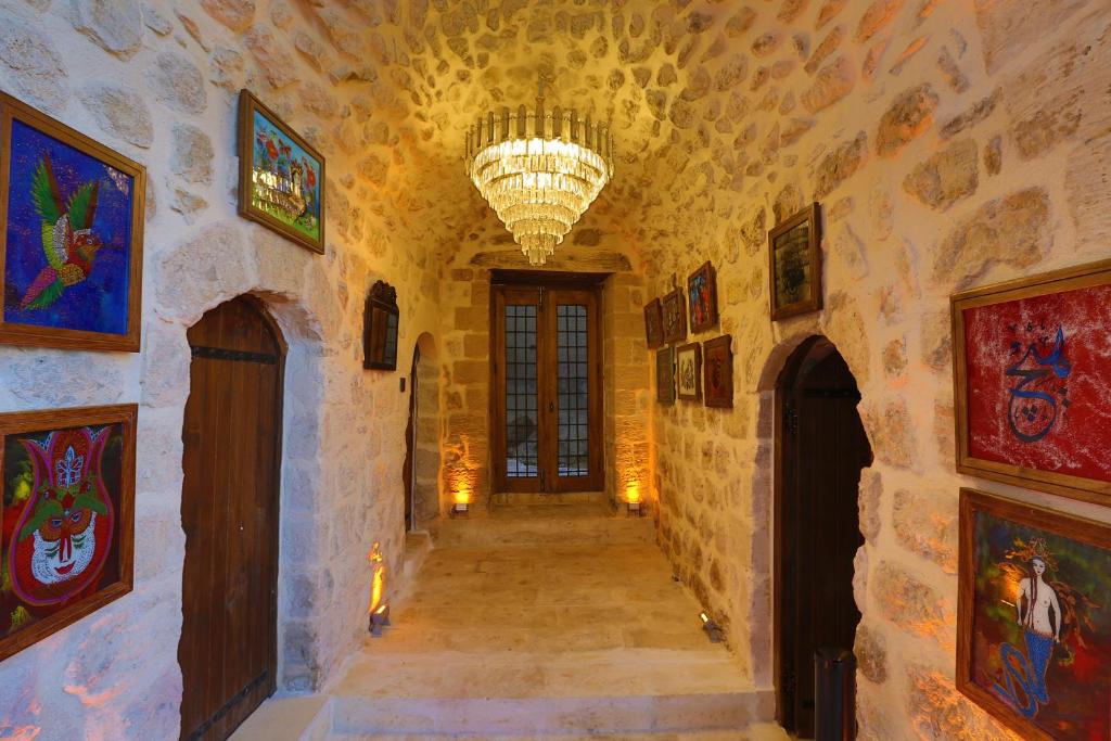 a hallway in a castle with a chandelier at Şems Inn in Mardin