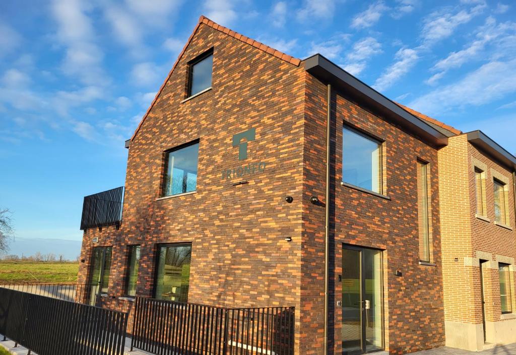 a brick house with a black fence at Trionfo 