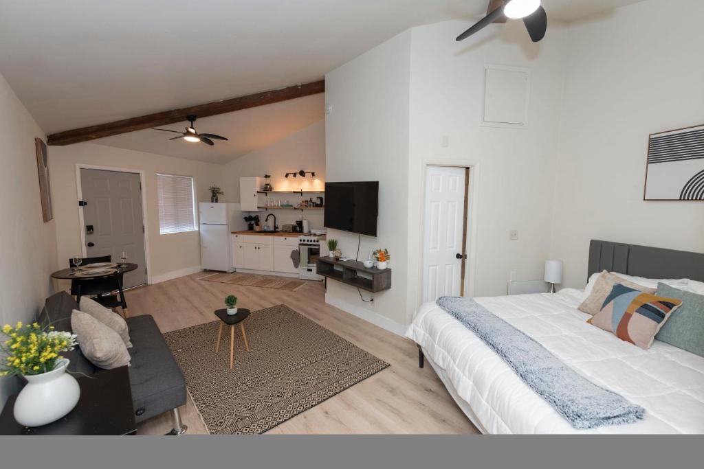 a bedroom with a large bed and a living room at Cozy Studio Apt Close to the Gardens - King Bed in Huntsville