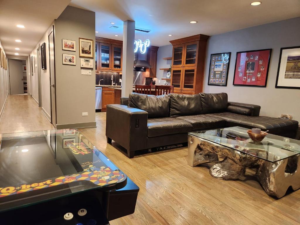 a living room with a couch and a table at Wrigley 2 bedroom 2 bath with free parking & yard! in Chicago