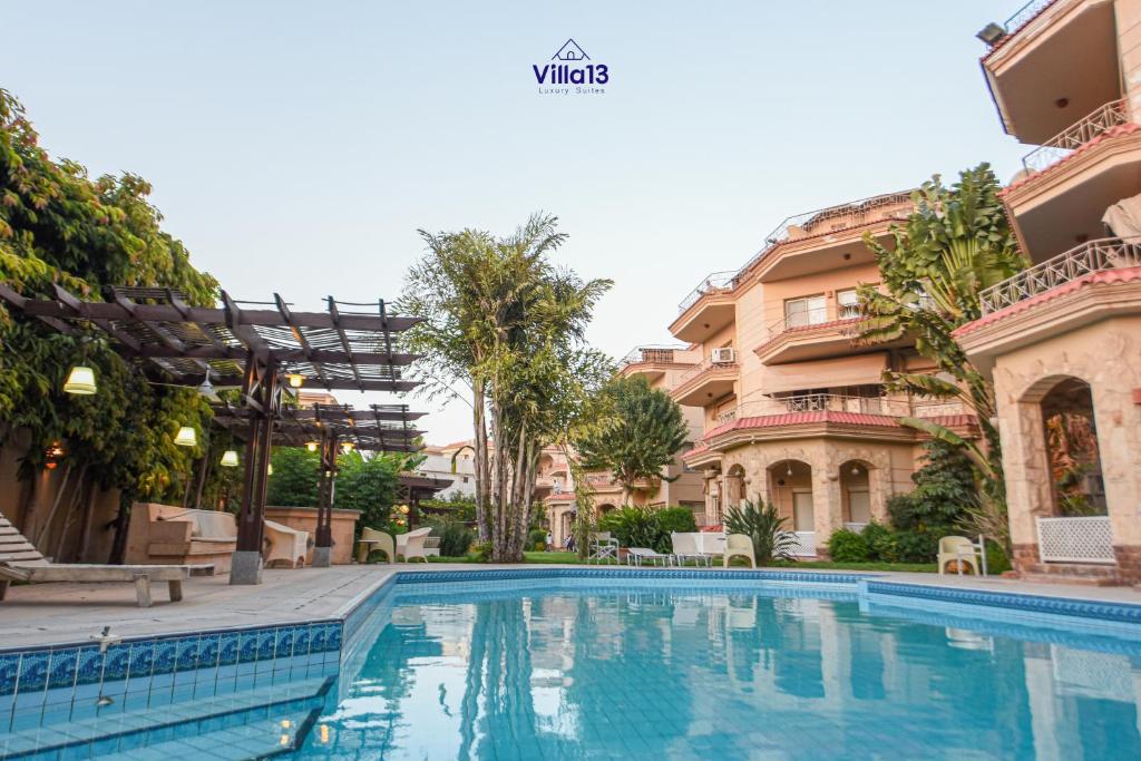 a swimming pool in front of a building at Villa 13 Luxury suites in Cairo