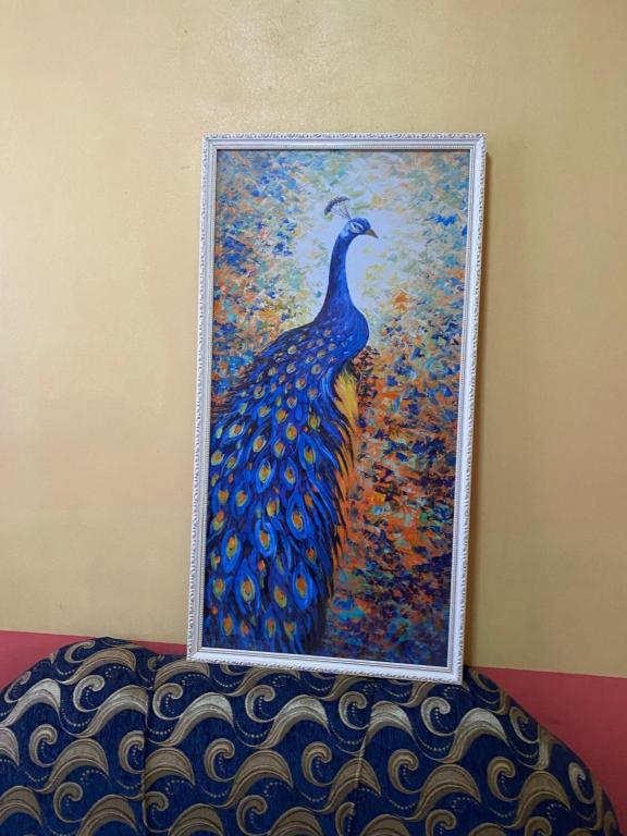 a painting of a peacock on a wall at Lusignan selfcontain apart two br and onebath in Georgetown