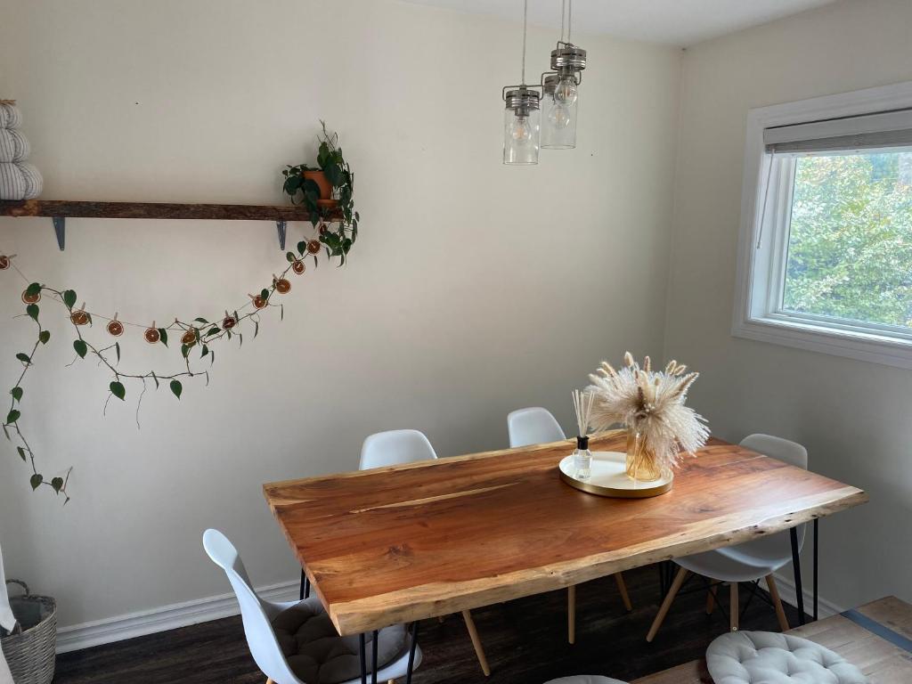 a dining room with a wooden table and white chairs at Great family choice in Whitby