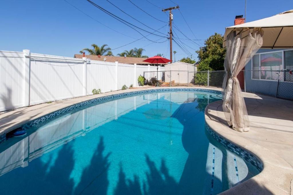 里弗赛德Private Room with Laundry and Pool access的房子里有蓝色水的游泳池