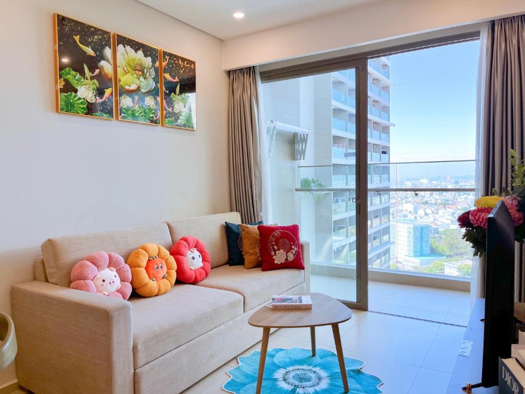 a living room with a couch with colorful pillows at BIG SALE 33percent The Song An Gia Vung Tau - Luxury 2Beds Apartment in Vung Tau