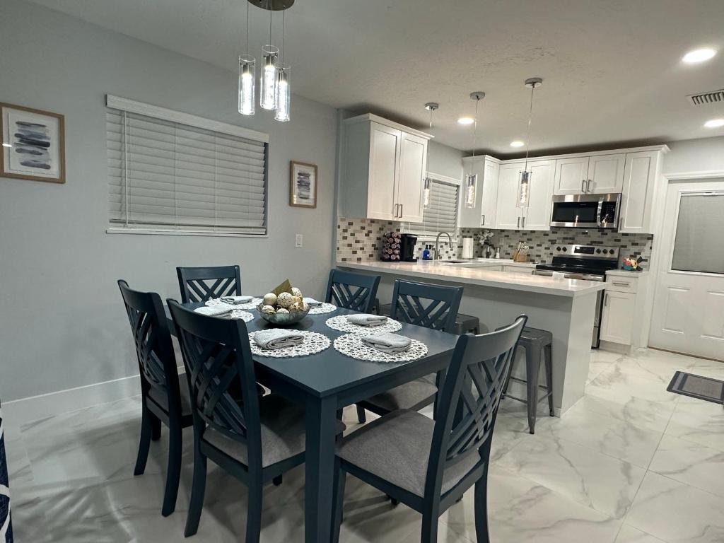 a kitchen and dining room with a table and chairs at Home Away From Home in Vero Beach