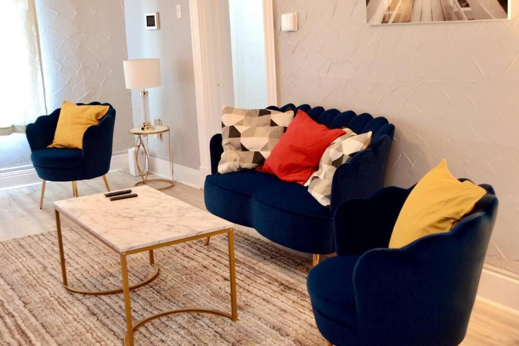 - un salon avec deux chaises bleues et une table dans l'établissement Charming Pittsburgh Haven with Modern Amenities, à Pittsburgh