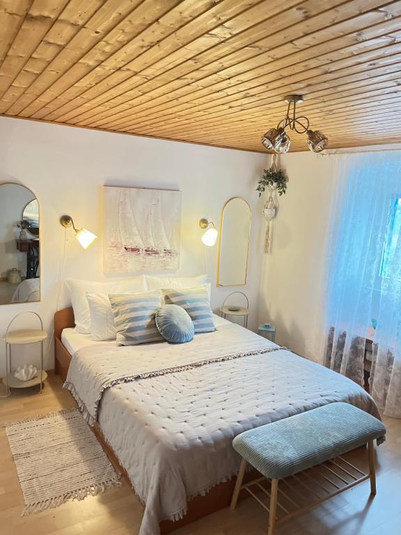 a bedroom with a large bed with blue pillows at Olivier house in Zaglav