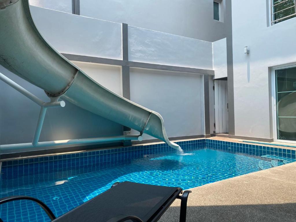 a slide in a swimming pool with a swimming pool at south pattaya,5BR modern villa in Pattaya Central