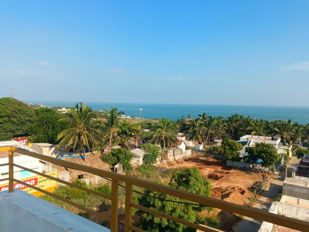 a view of the ocean from the balcony of a resort at HOTEL AATHANAM in Kanyakumari