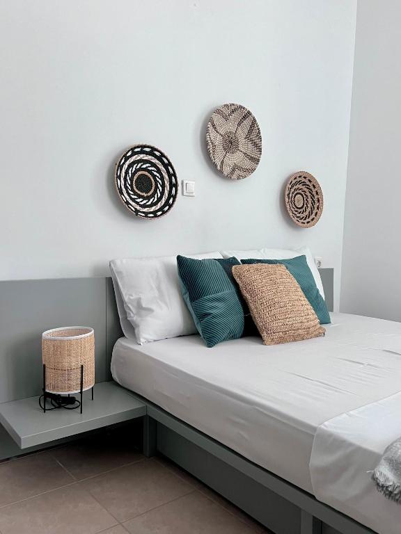 a bed with pillows on it in a room at Casa by Hokkum Studios in Kokkari