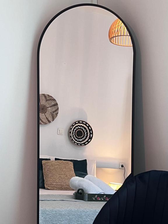 a mirror in front of a bedroom with a bed at Casa by Hokkum Studios in Kokkari