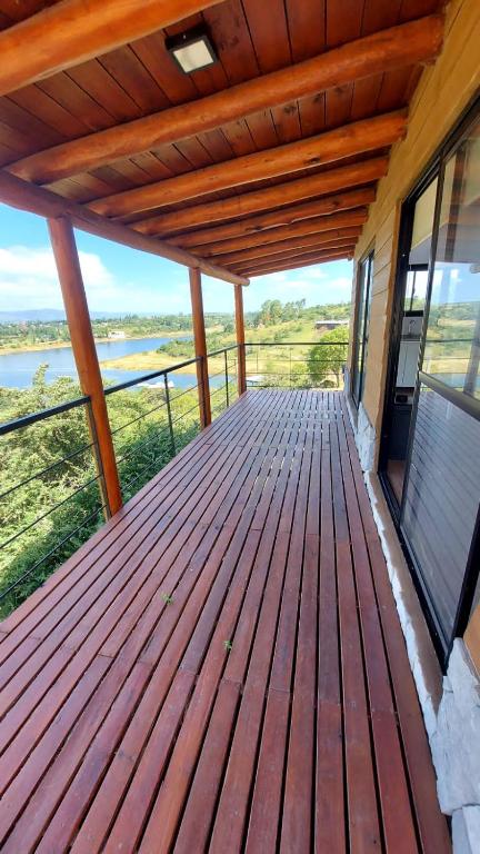 a wooden deck with a view of the water at Mansavista Cabañas in Potrero de Garay