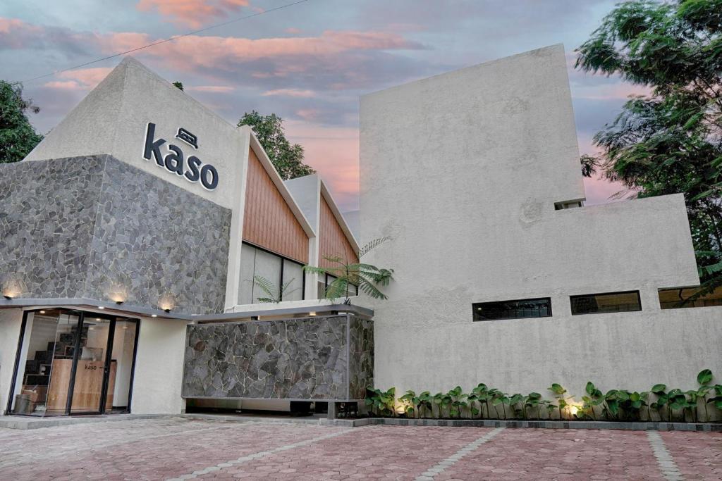 a white building with a kasco sign on it at Kaso Urban Villa in Kejayan