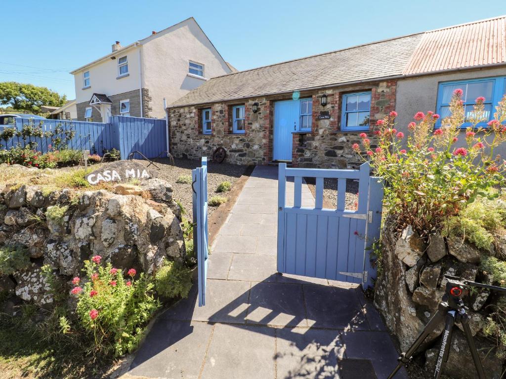 a blue gate in front of a house at Casa Mia in Goodwick