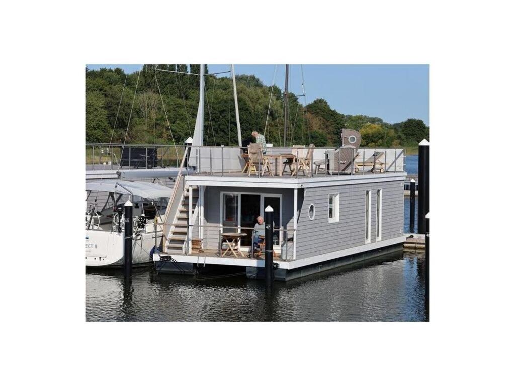 un pequeño barco está atracado en un muelle en Houseboat Lilliput, en Stralsund