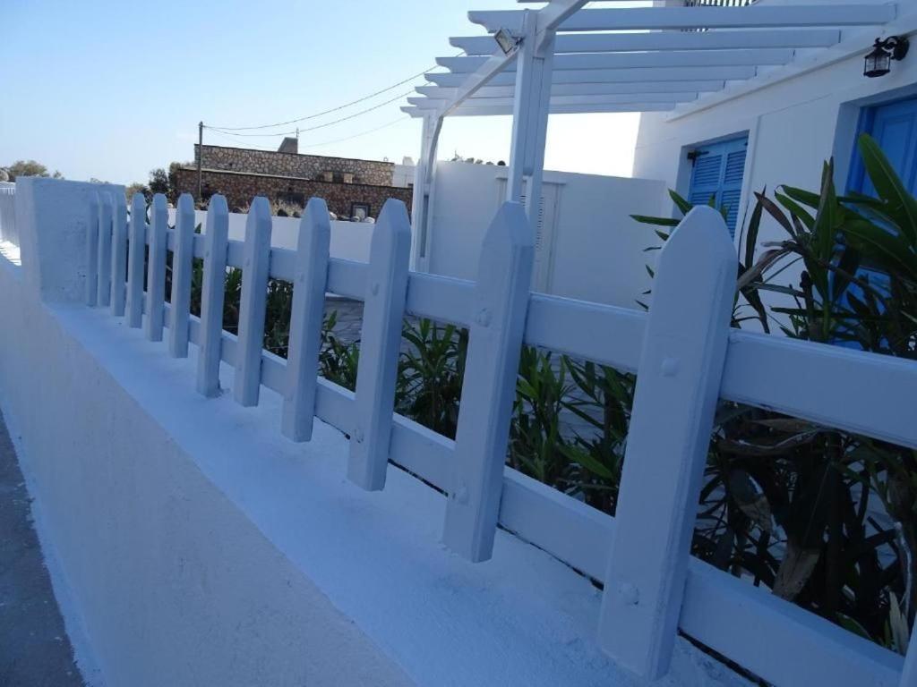 a white fence in front of a house at Splendid Santorini Villa | Bella Beach House | 3 Bedrooms | Private Terrace and Beautiful Sea Views | Monolithos in Monolithos