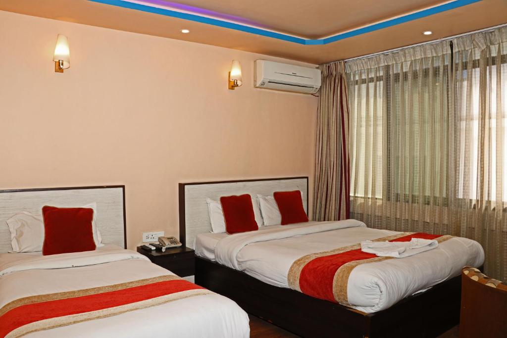 Postel nebo postele na pokoji v ubytování Hotel Readers Inn Pvt.Ltd