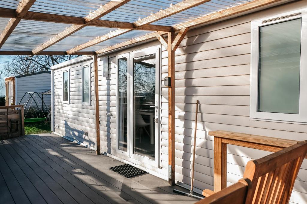 a pergola over a porch on a house at Magnolia - Camping Belle-Vue in Berdorf
