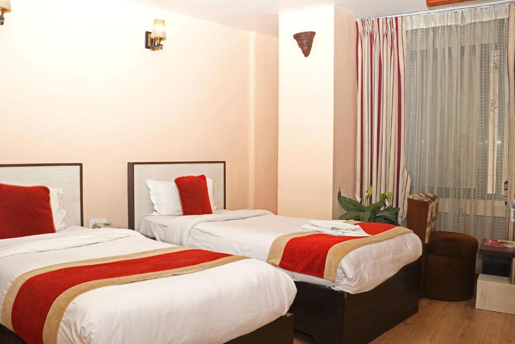 Postel nebo postele na pokoji v ubytování Hotel Readers Inn Pvt.Ltd