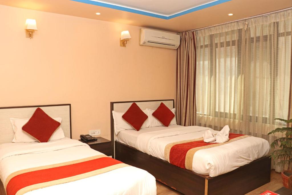 Postel nebo postele na pokoji v ubytování Hotel Readers Inn Pvt.Ltd