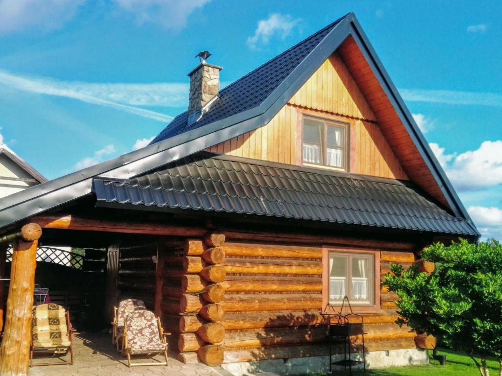 Cabaña de madera con techo negro en Holiday home in Kopalino, en Kopalino