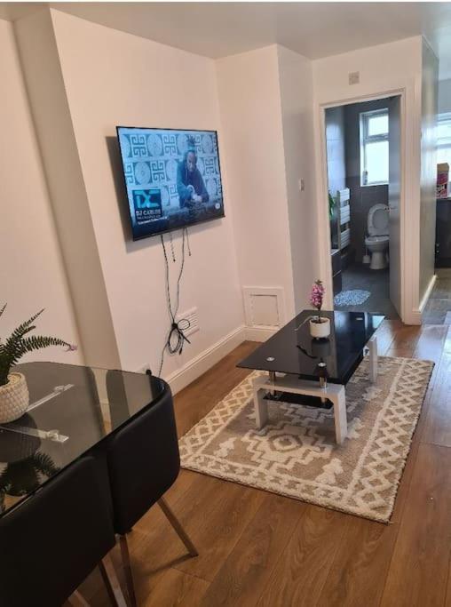 a living room with a table and a dining room at Lovely luxury one bedroom flat in London