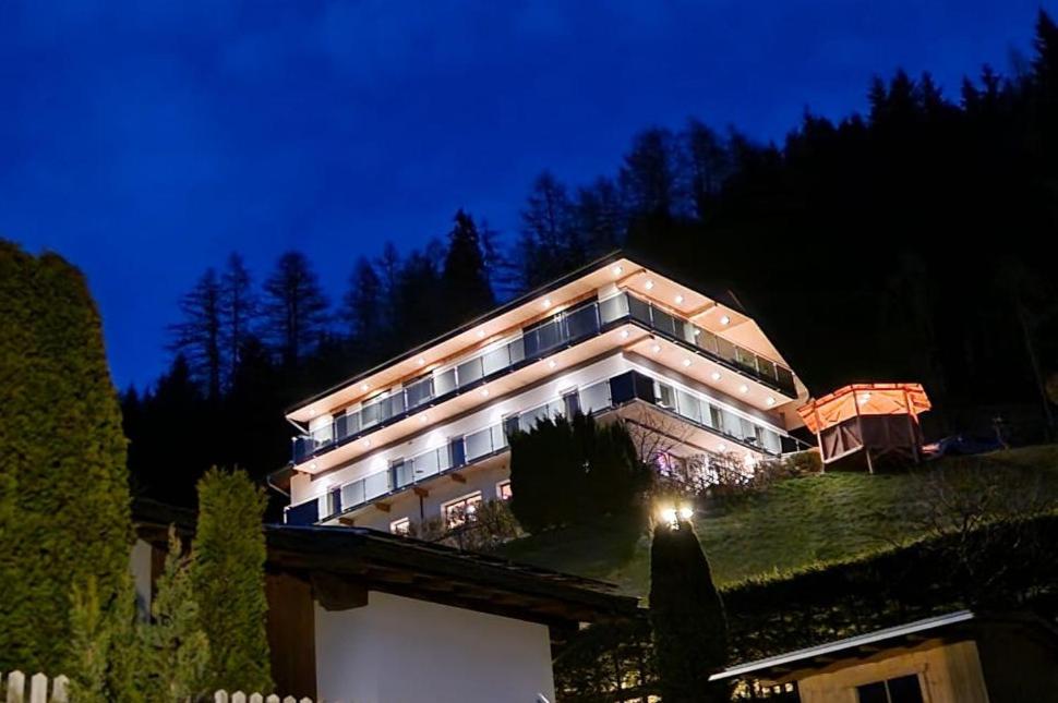 ein großes Gebäude auf einem Hügel in der Nacht in der Unterkunft Haus Berghof in Gries am Brenner