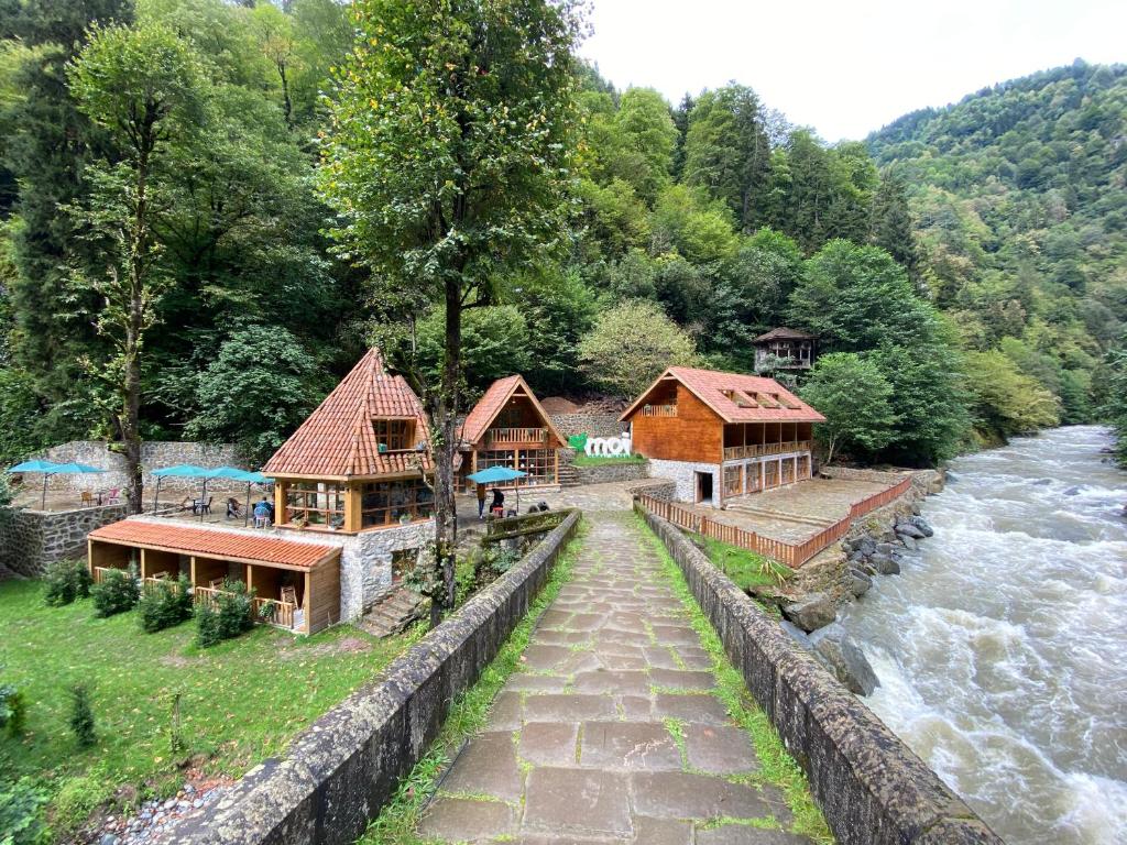 a group of buildings next to a river at Moi in Rize