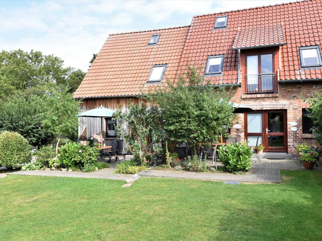 a large brick house with a garden and a yard at Fabulous Holiday Home in Thorstorf near Sea in Thorstorf